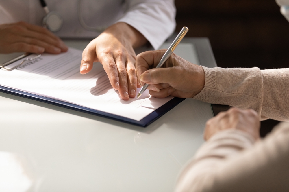 Photo of a Woman Filling Out Form