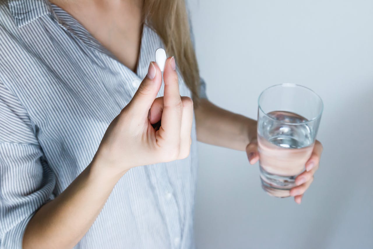 Photo of a Person Taking Medicine